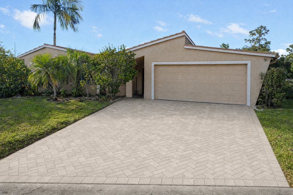 New herringbone paver driveway in front of a South Florida home (illustrative rendering)