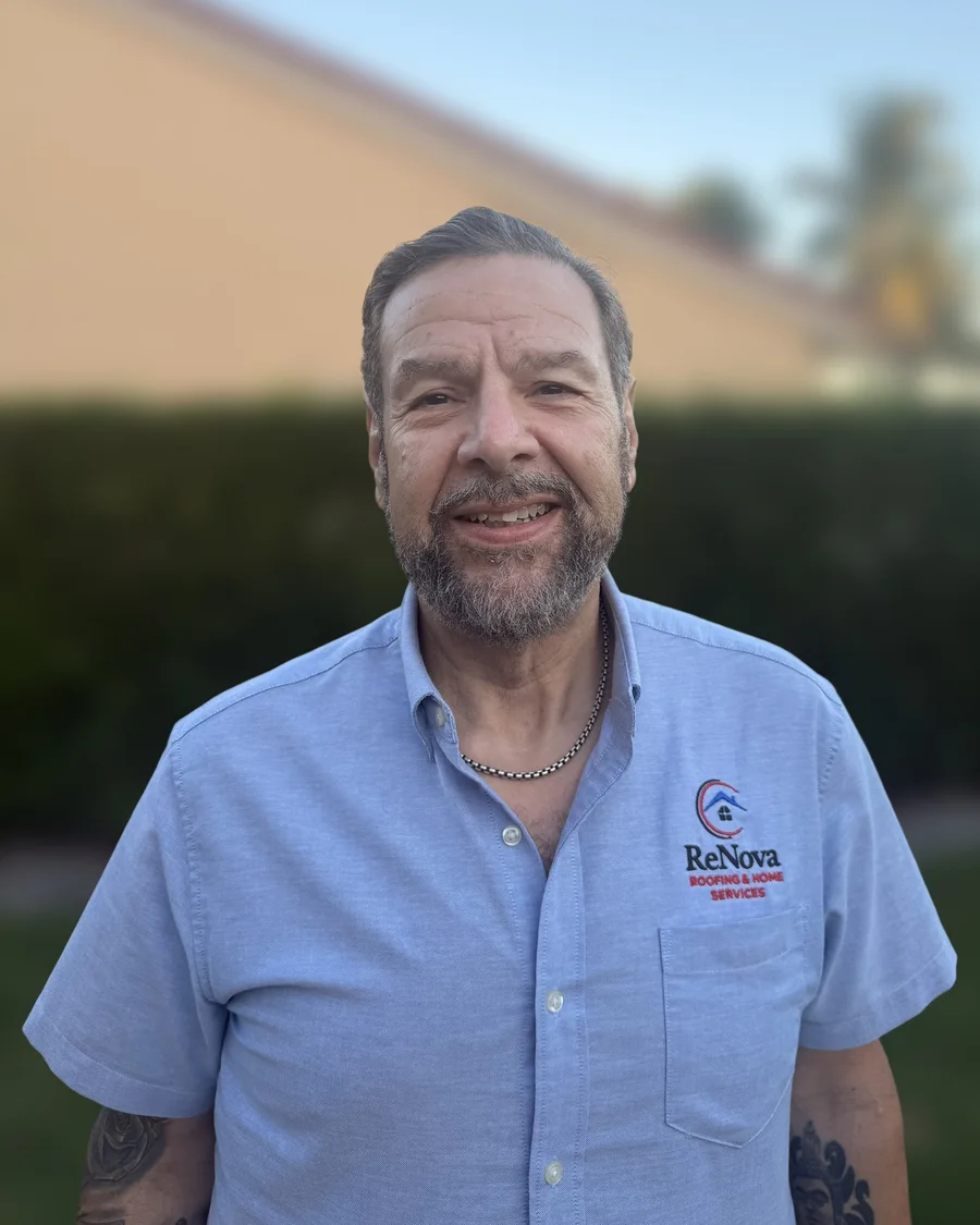 Miguel Martinez, President of ReNova, in a ReNova shirt outside a South Florida home
